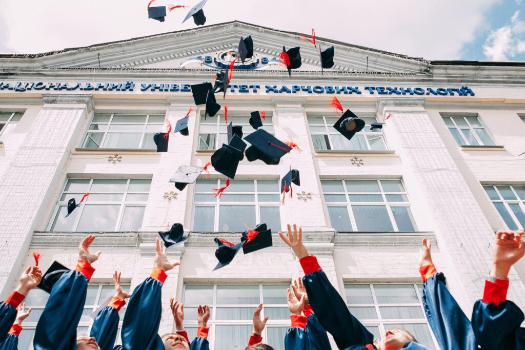Graduates throwing caps in air