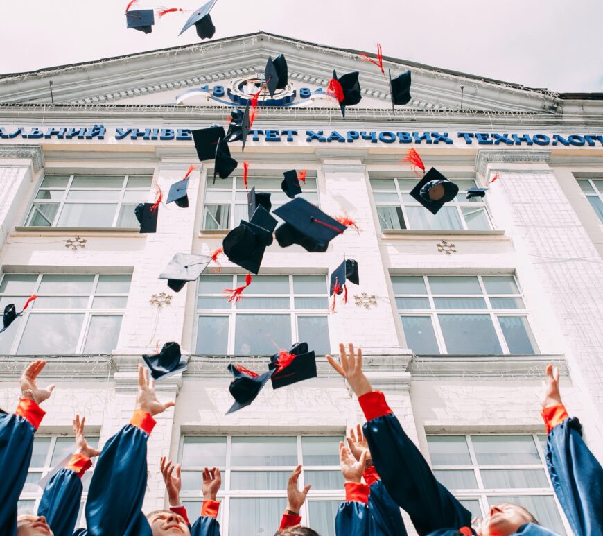 Graduates throwing caps in air