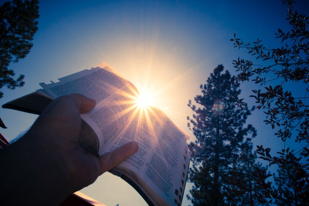 Religious book being held up
